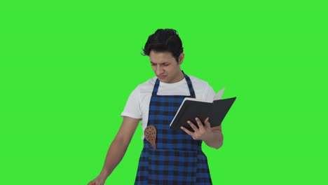 Confused-Indian-cook-making-food-from-recipe-book-Green-screen