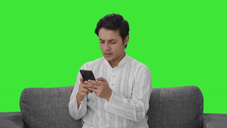 Angry-Indian-man-chatting-on-phone-Green-screen