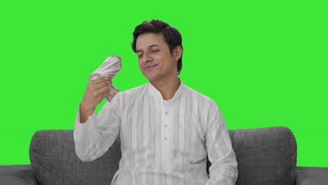 Happy-Indian-man-using-money-as-fan-Green-screen