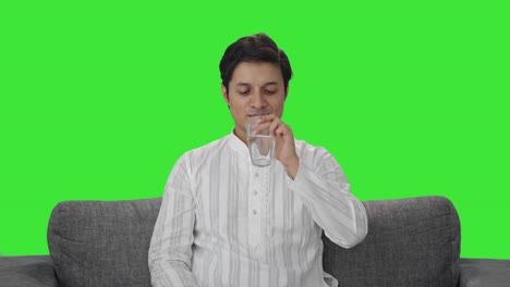 Happy-Indian-man-taking-medicine-Green-screen