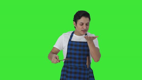 Happy-Indian-cook-tasting-good-food-and-giving-chef-kiss-to-food-Green-screen