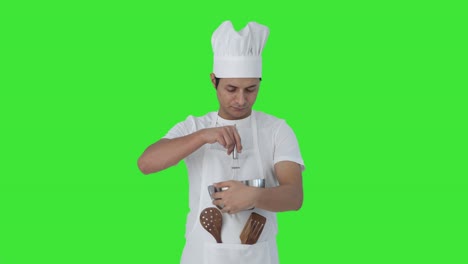 Indian-professional-chef-whisking-flour-in-bowl-Green-screen