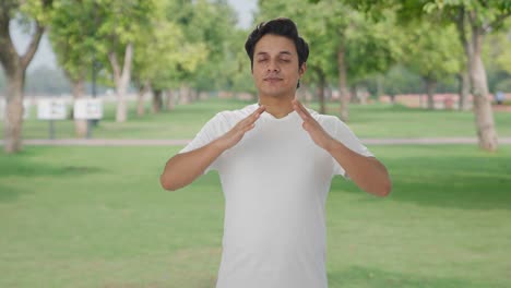 Happy-Indian-man-doing-breathe-in-breathe-out-exercise