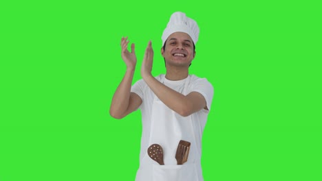 Happy-Indian-professional-chef-clapping-and-appreciating-Green-screen