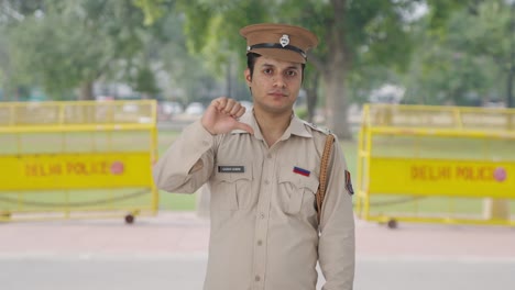 Disappointed-Indian-police-officer-showing-thumbs-down