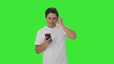 Happy-Indian-man-listening-songs-on-earphone-and-dancing-Green-screen