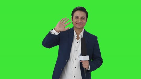 Happy-Indian-reporter-saying-hello-Green-screen