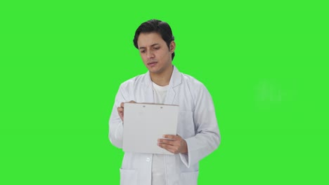 Indian-scientist-writing-observations-on-papers-Green-screen