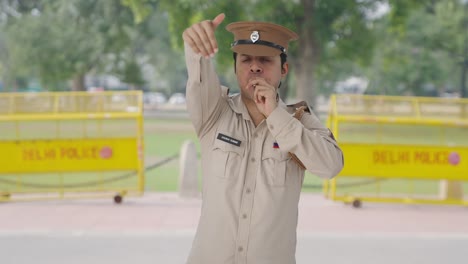 Angry-Indian-police-officer-calling-someone-using-whistle