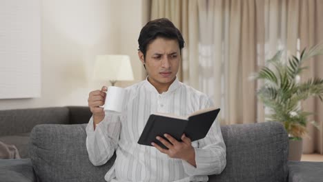 Confused-Indian-man-reading-a-book