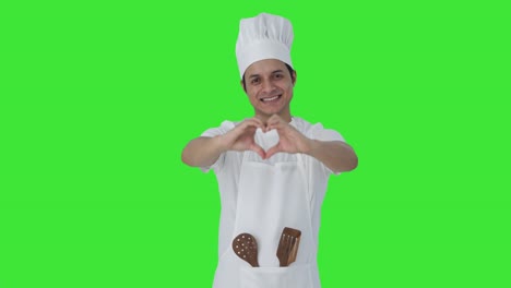 Happy-Indian-professional-chef-showing-heart-sign-Green-screen