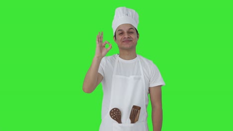 Happy-Indian-professional-chef-giving-chef-kiss-Green-screen