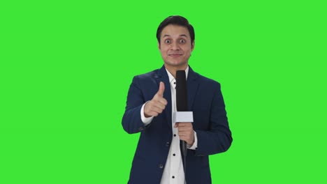 Happy-Indian-reporter-showing-thumbs-up-Green-screen