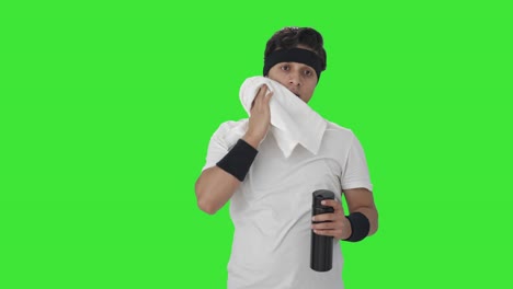 Indian-man-wiping-sweat-and-drinking-water-Green-screen