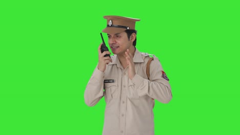 Angry-Indian-police-officer-giving-instructions-on-walkie-talkie-Green-screen