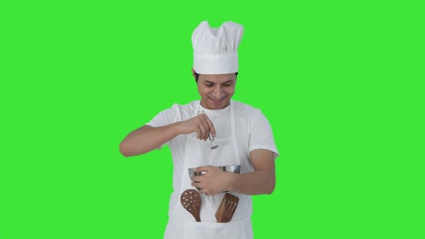 Happy-Indian-professional-chef-whisking-flour-Green-screen