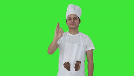 Happy-Indian-professional-chef-showing-okay-sign-Green-screen