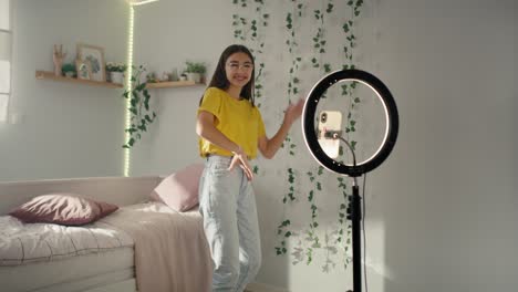 Teenage-caucasian-girl-dancing-and-recording-video-for-social-media-using-ring-light