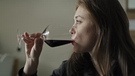 Caucasian-woman-with-problems-drinking-red-wine-at-home.