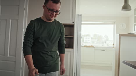 Caucasian-man-with-down-syndrome-vacuuming-at-home.