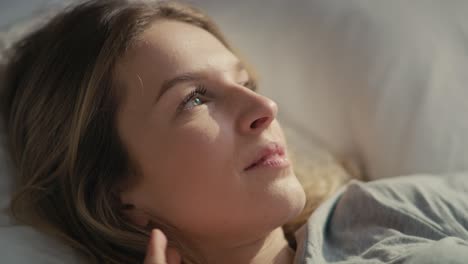 Close-up-of-caucasian-woman-enjoying-the-sunset-in-bed.