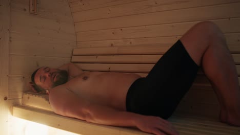Caucasian-man-enjoying-in-the-sauna-in-winter.