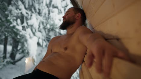 Caucasian-man-enjoying-in-the-sauna-in-winter.