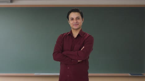 Portrait-of-Happy-Indian-teacher-standing-crossed-hands