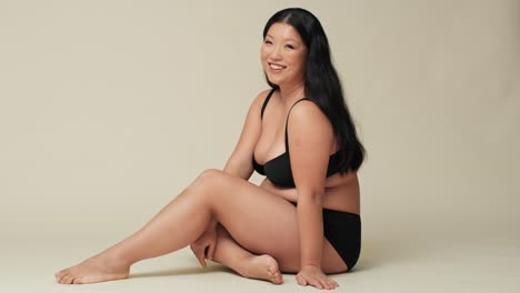 Chinese-woman-in-underwear-sitting-on-the-floor-in-the-studio