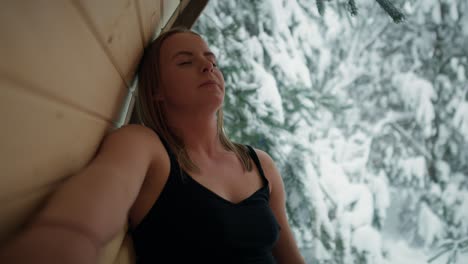 Caucasian-woman-enjoying-in-the-sauna-in-winter.