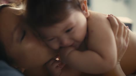Close-up-of-Asian-mother-playing-with-her-baby-boy