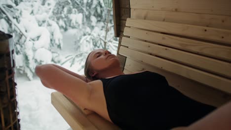 Caucasian-woman-enjoying-in-the-sauna-in-winter