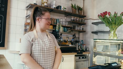 Caucasian-woman-with-down-syndrome-passing-take-away-food-to-a-female-client