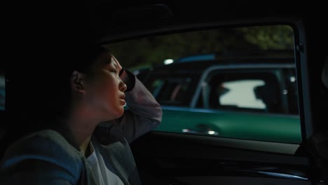 Mujer-China-De-Negocios-Conduciendo-En-Un-Taxi-Por-La-Noche