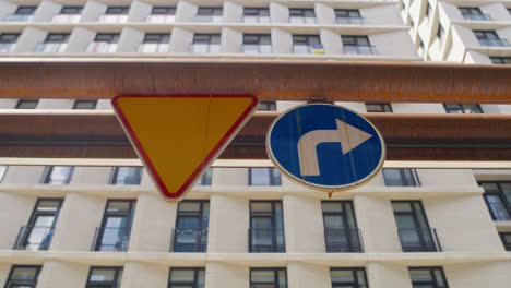 Two-road-signs-on-the-building
