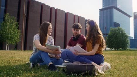 Wide-shot-of-group-of-caucasian-students-studying-outside-the-university-campus