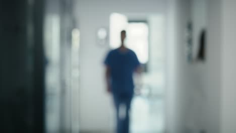 Blurred-video-of-medical-staff-walking-across-the-hospital-corridor