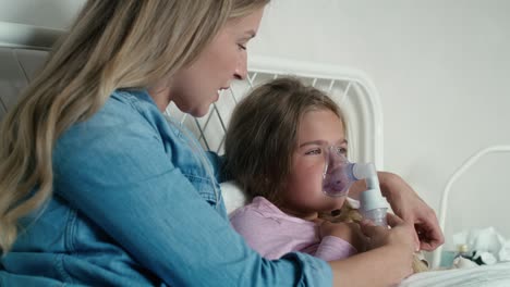 Mother-giving-nebulizer-to-an-ill-child-at-home
