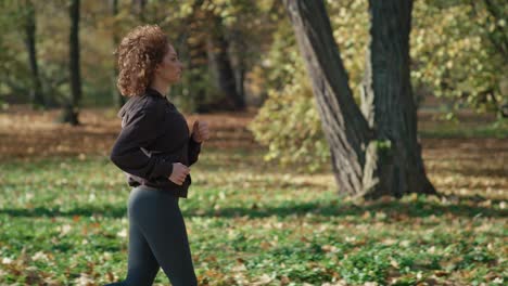 Caucasian-of-ginger-woman-jogging-at-the-park-in-autumn