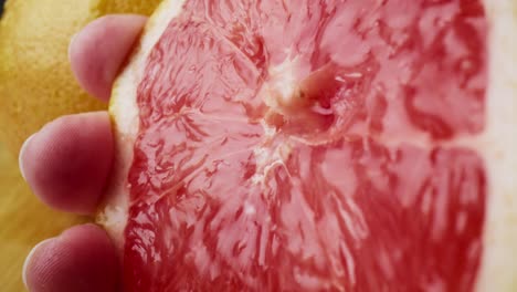 Macro-video-of-hand-squeezing-juice-from-grapefruit