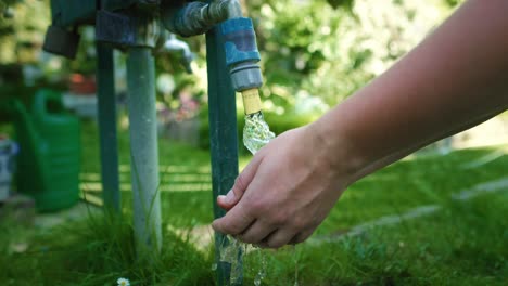 Gardener-washing-hands-in-the-outdoors-tap