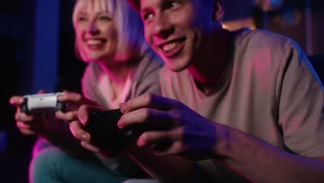 Detail-of-young-caucasian-couple-playing-video-game-with-game-pad