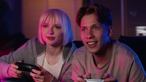 Young-caucasian-couple-playing-video-game-with-game-pad
