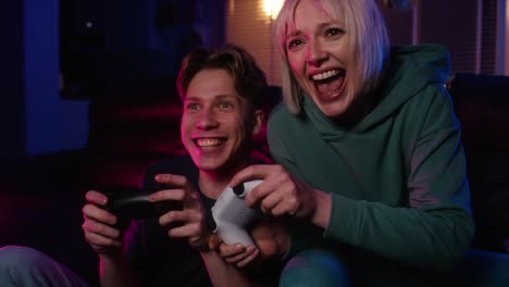 Young-caucasian-couple-playing-video-game-with-game-pads