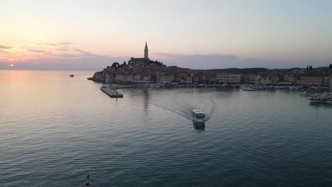 A-drone-shot-of-the-small-harbor-of-Rovinj,-Croatia-during-sunset