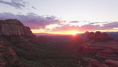 Red-yellow-golden-rays-from-sun-cast-over-hiking-trail-to-Merry-go-round-red-rock-canyon-of-Sedona-Arizona