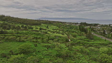 Maui-Hawaii-Aerial-v13-drone-flyover-Kapalua-Golf-course-resort-captures-its-lush-neighborhood,-stunning-coastal-vistas,-and-views-of-Molokaʻi-and-Lanai-island---Shot-with-Mavic-3-Cine---December-2022