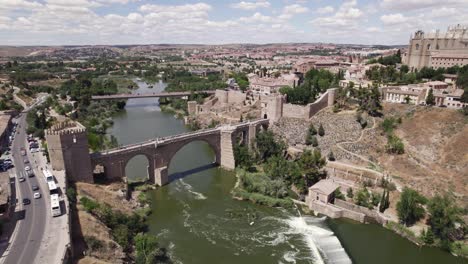 Puente-de-San-Martín-medieval-bridge-across-the-river-Tagus-in-Spain,-aerial-view