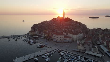 The-small-fishing-port-of-Rovinj,-Croatia-watches-the-sun-set-over-the-Adriatic-Sea