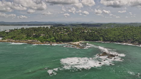 Mirissa-Sri-Lanka-Aerial-v19-flyover-Palapana-Gala-Reef-capturing-rugged-coastline,-secret-beach-with-pristine-sand-and-clear-water-and-hillside-resort-hotels---Shot-with-Mavic-3-Cine---April-2023